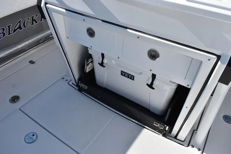 Slide: The Image of 2023 Blackfin 272CC boat with Yeti cooler storage compartment. - 42