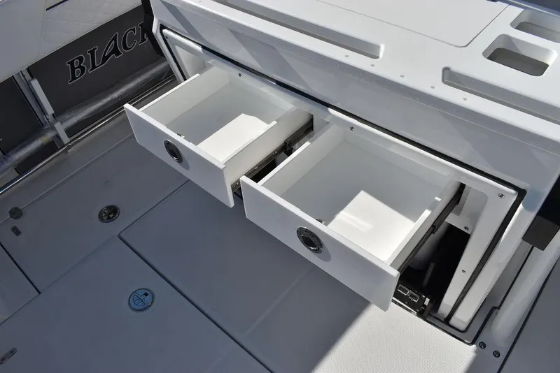 Slide: The Image of 2023 Blackfin 272CC boat with open storage drawers on deck. - 43