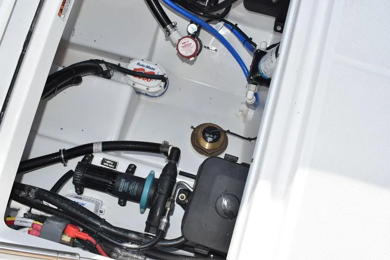 Slide: The Image of 2023 Blackfin 272CC boat engine compartment with various components and wiring. - 49