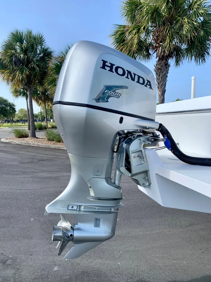 Slide: The Image of 2004 Pro-Line 25 Sport boat with Honda outboard motor. - 16