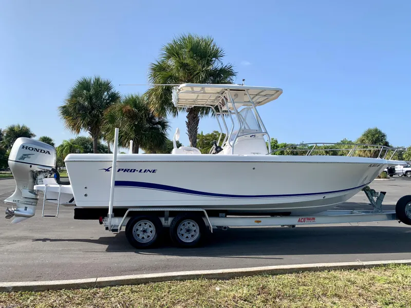 Slide: The Image of 2004 Pro-Line 25 Sport boat on trailer with Honda outboard motor. - 17