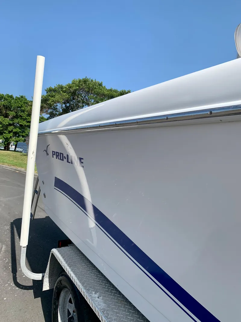 Slide: The Image of 2004 Pro-Line 25 Sport boat on a trailer, side view. - 22