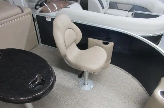 Slide: The Image of 2023 Sylvan MIRAGE 8522 Party Fish 4.0 boat interior with beige seating and table. - 3
