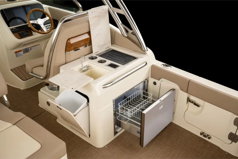 Slide: The Image of 2023 Chris-Craft Calypso 27 boat interior with kitchenette and storage. - 11