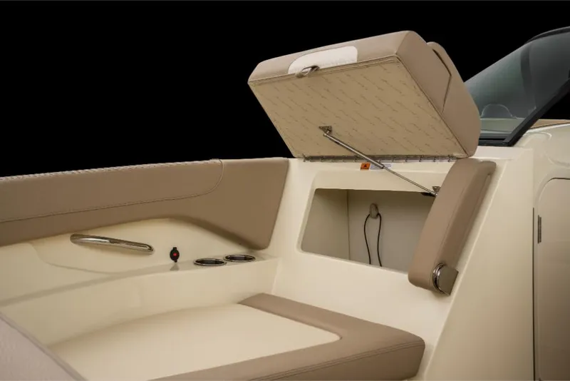 Slide: The Image of 2023 Chris-Craft Calypso 27 boat interior with open storage compartment and beige seating. - 15