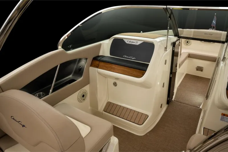 Slide: The Image of 2023 Chris-Craft Calypso 27 interior, luxury boat seating and dashboard. - 16