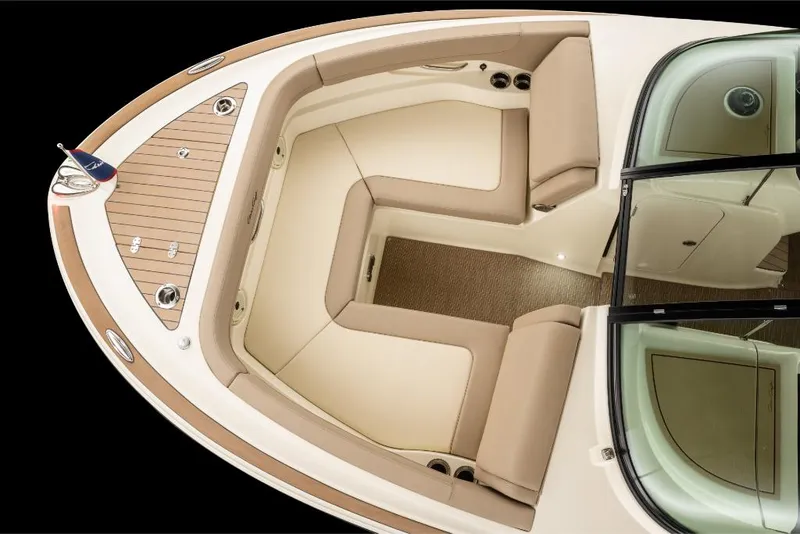 Slide: The Image of 2023 Chris-Craft Calypso 27 boat interior with beige seating and wooden flooring. - 19