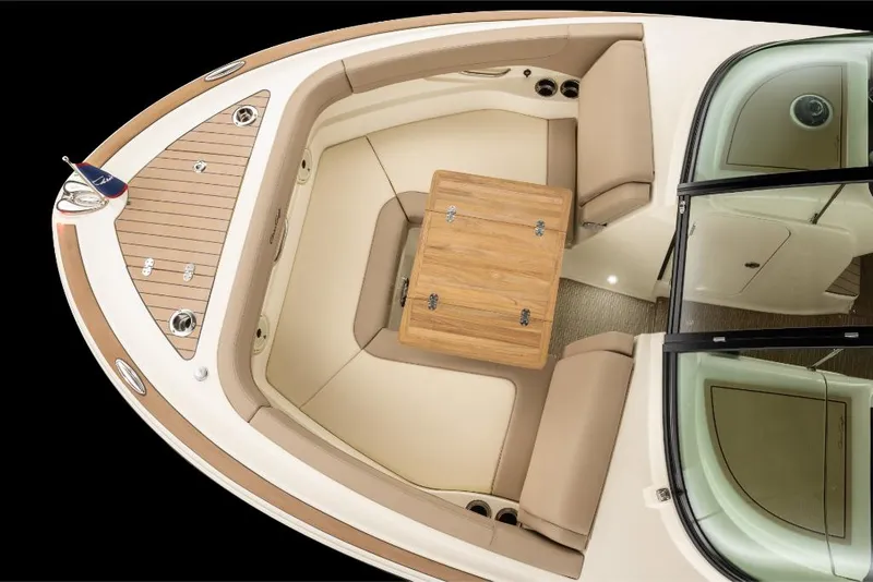 Slide: The Image of 2023 Chris-Craft Calypso 27 boat interior with beige seating and wooden table. - 23