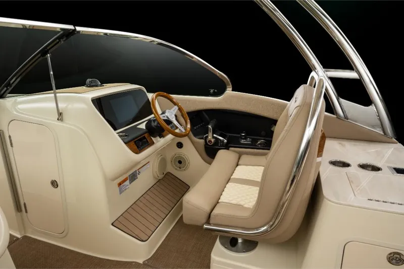 Slide: The Image of 2023 Chris-Craft Calypso 27 boat interior with beige seating and modern dashboard. - 24