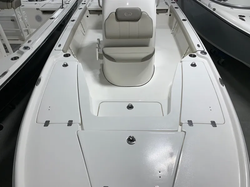 Slide: The Image of 2024 Key West 210 Bay Reef boat interior with seating and storage compartments. - 14