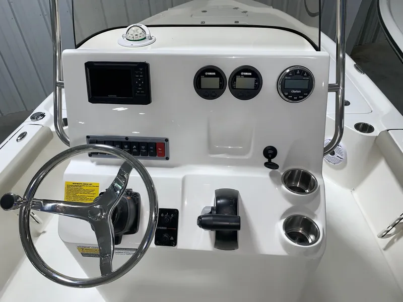 Slide: The Image of 2024 Key West 210 Bay Reef boat console with steering wheel and gauges. - 4