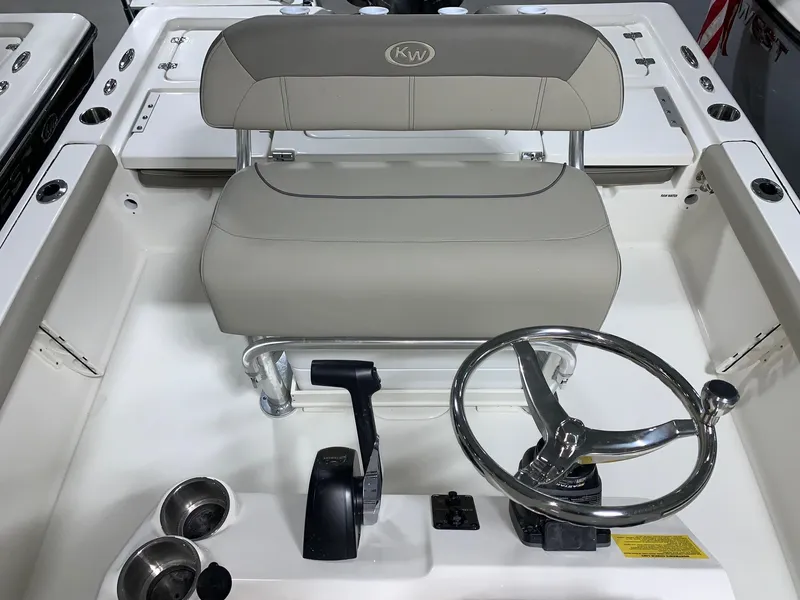 Slide: The Image of 2024 Key West 210 Bay Reef boat helm with steering wheel and controls. - 8
