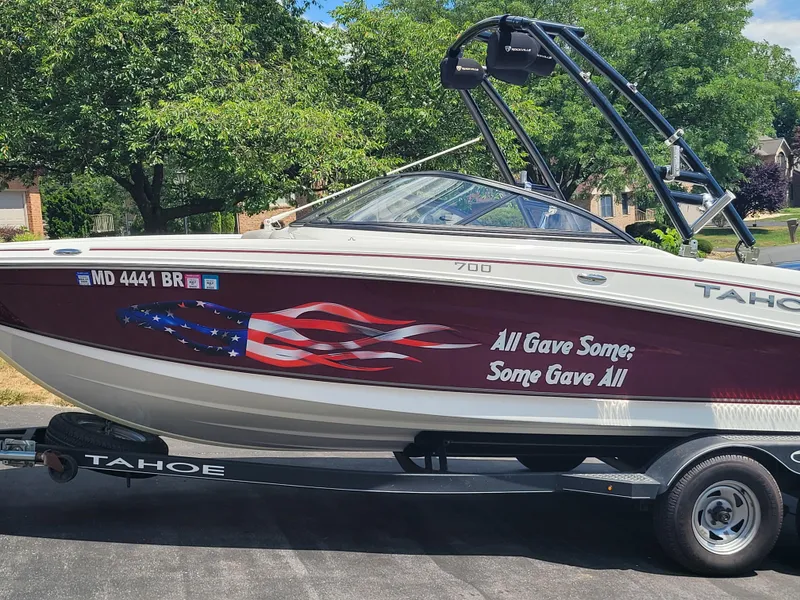 The Image of 2020 Tahoe 700 boat with patriotic graphics and "All Gave Some; Some Gave All" text. - 0