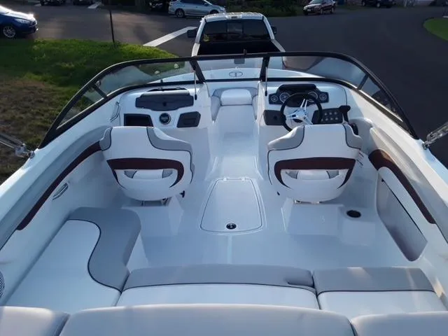 Slide: The Image of 2020 Tahoe 700 boat interior with white and brown seating, steering wheel, and dashboard. - 3