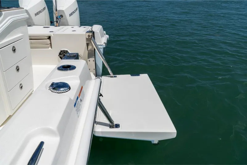 Slide: The Image of 2023 Boston Whaler 280 Dauntless boat with swim platform and dual Mercury engines. - 24
