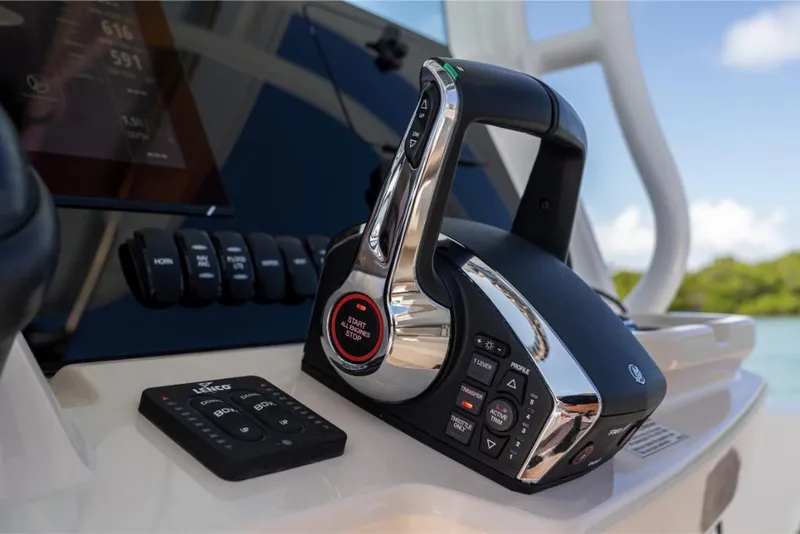 Slide: The Image of 2023 Boston Whaler 280 Dauntless control panel and throttle. - 32