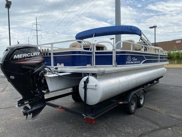 Slide: The Image of 2017 Sun Tracker Fishin' Barge 24 DLX pontoon boat with Mercury outboard motor. - 2