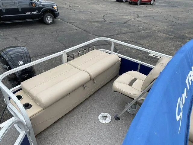 Slide: The Image of 2017 Sun Tracker Fishin' Barge 24 DLX pontoon boat with beige seating and Mercury outboard motor. - 6