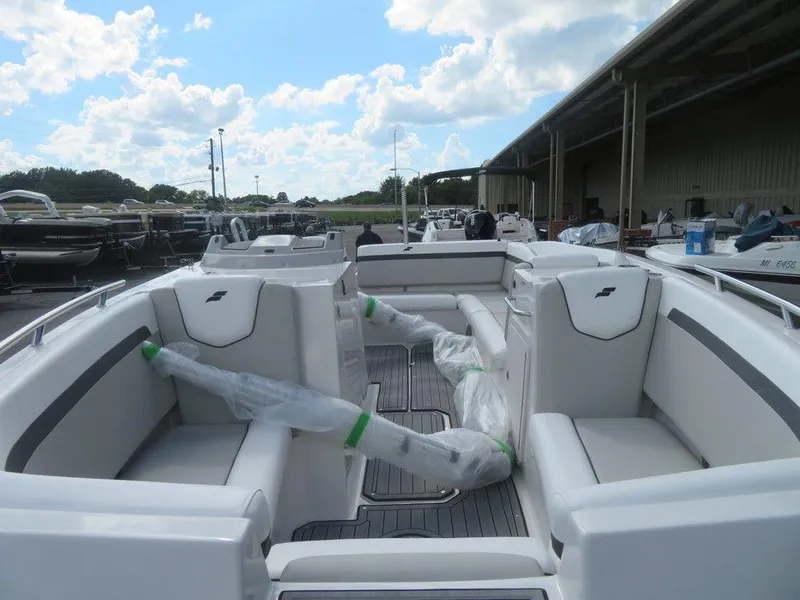 Slide: The Image of 2023 Starcraft SVX OB 231 OB boat interior with white seating and open deck. - 10