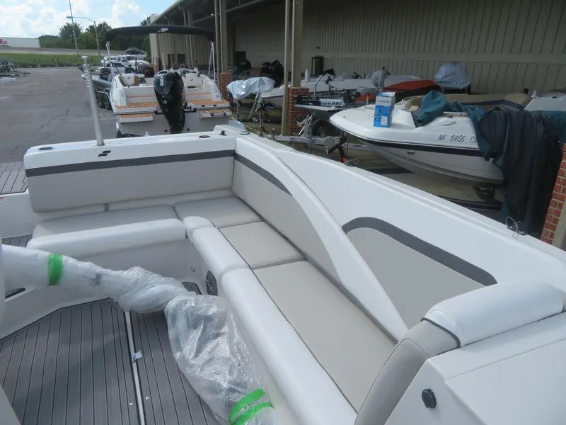 Slide: The Image of 2023 Starcraft SVX OB 231 OB boat with spacious seating at a marina. - 6