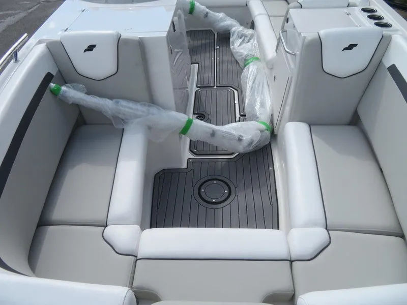 Slide: The Image of 2023 Starcraft SVX OB 231 OB boat interior with cushioned seating and wrapped components. - 7