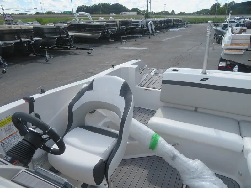 Slide: The Image of 2023 Starcraft SVX OB 231 OB boat interior with captain's chair and seating area. - 9