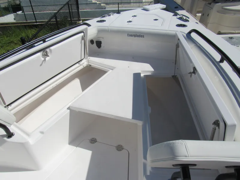 Slide: The Image of 2023 Everglades 253 CC boat interior with open storage compartments. - 12
