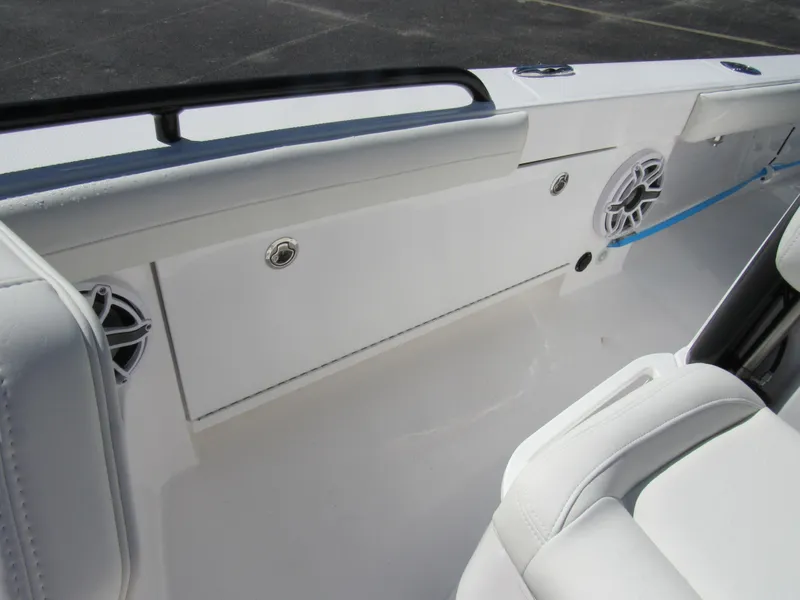 Slide: The Image of Interior of 2023 Everglades 253 CC boat, featuring white seating and built-in speakers. - 15