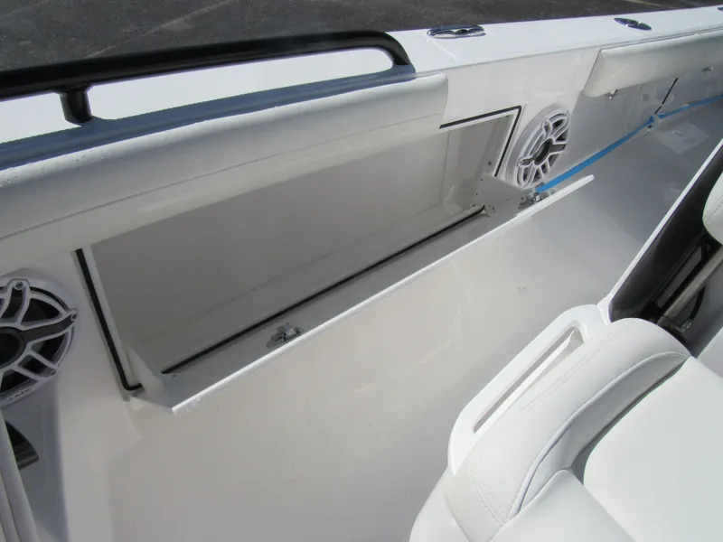 Slide: The Image of Open storage compartment on 2023 Everglades 253 CC boat with white interior. - 16