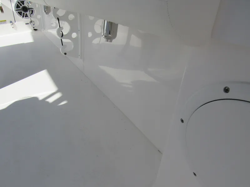 Slide: The Image of Interior view of 2023 Everglades 253 CC boat showing white deck and storage compartments. - 17