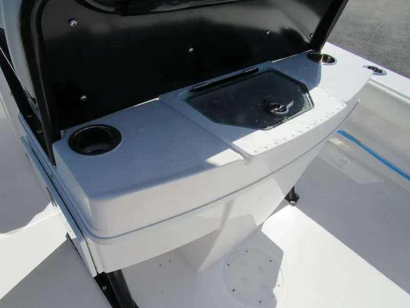 Slide: The Image of 2023 Everglades 253 CC boat console with cup holders and storage compartment. - 19