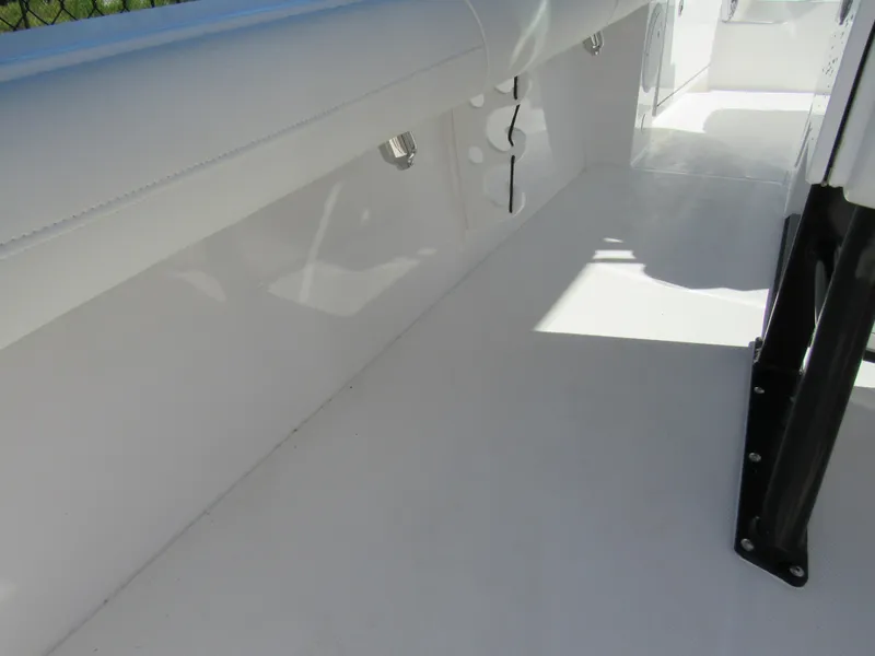 Slide: The Image of Interior view of 2023 Everglades 253 CC boat, featuring white seating and clean deck. - 20