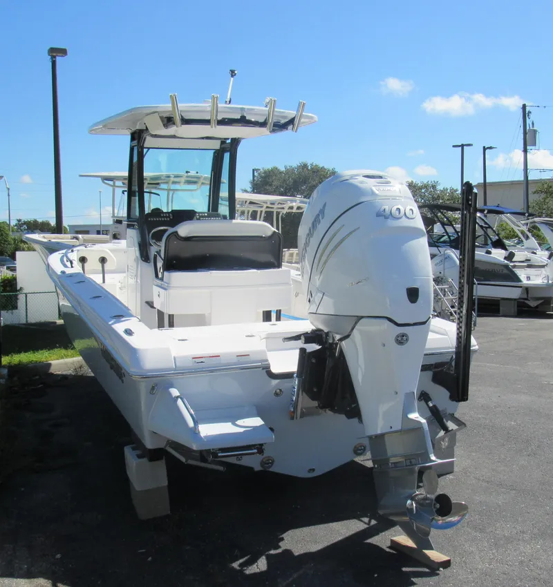 Slide: The Image of 2023 Everglades 253 CC boat with Mercury 400 outboard motor in a marina. - 24