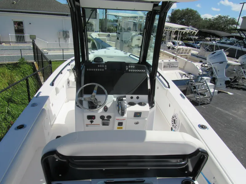 Slide: The Image of 2023 Everglades 253 CC center console boat interior with steering wheel and controls. - 25