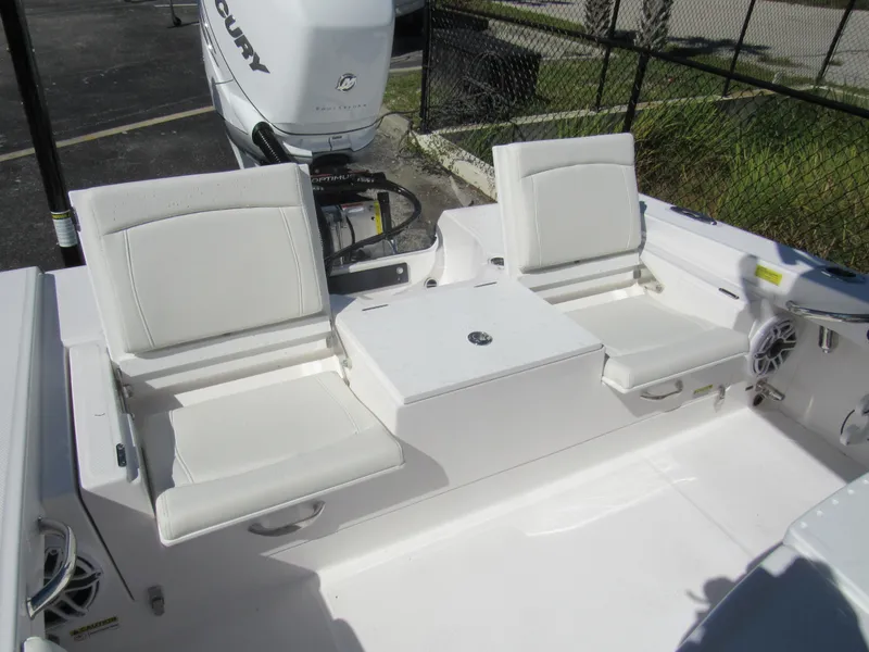 Slide: The Image of 2023 Everglades 253 CC boat with white seating and Mercury outboard motor. - 3