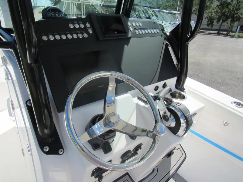 Slide: The Image of 2023 Everglades 253 CC boat helm with steering wheel and control panel. - 6