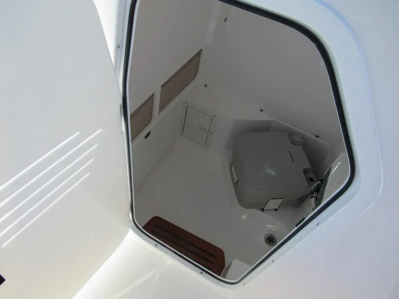 Slide: The Image of Interior view of 2023 Everglades 253 CC boat's compact restroom. - 9