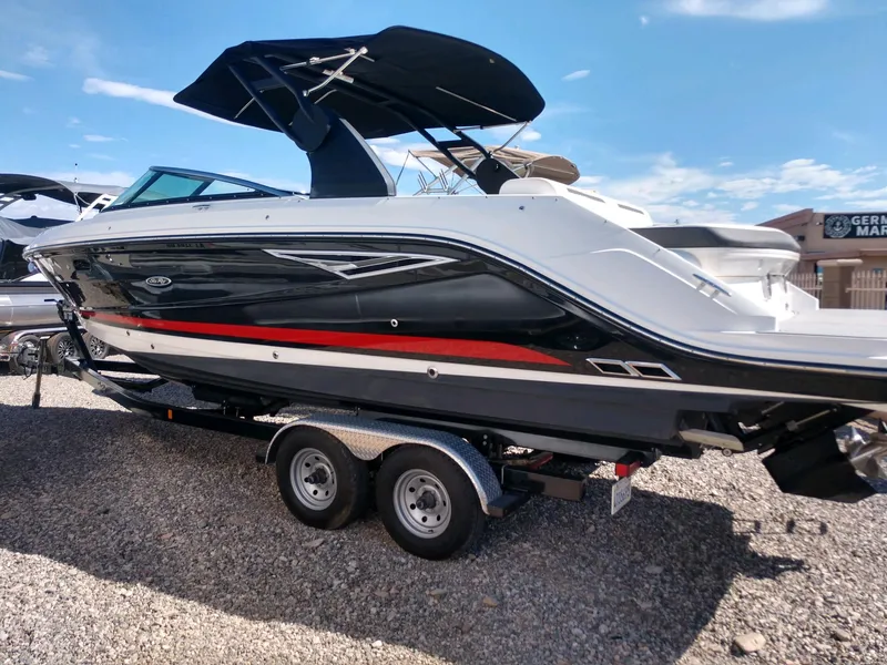 The Image of 2018 Sea Ray SLX 280 boat on a trailer under a clear blue sky. - 1