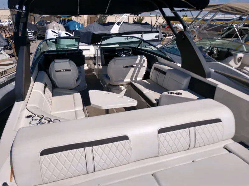 Slide: The Image of 2018 Sea Ray SLX 280 boat interior with white seating and steering console. - 10