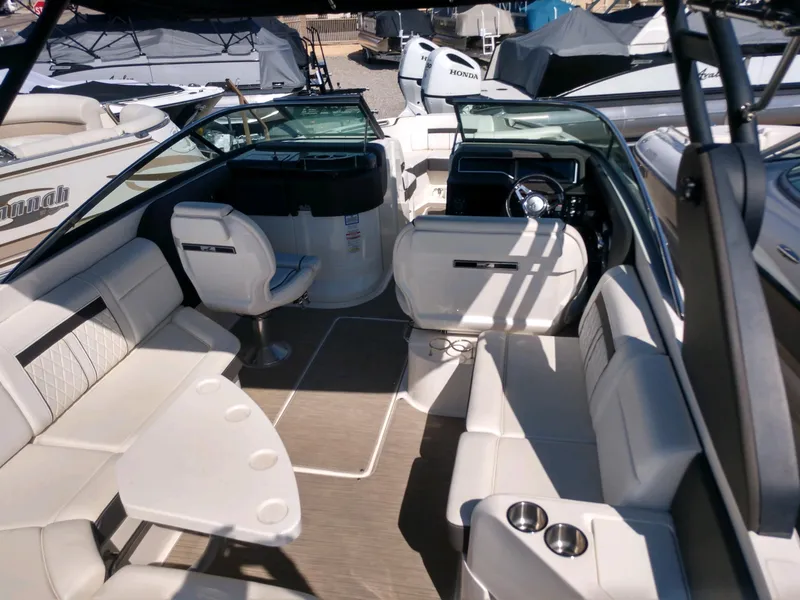 Slide: The Image of 2018 Sea Ray SLX 280 boat interior with white seating and steering console. - 11