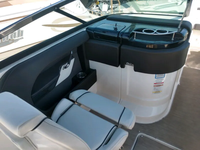 Slide: The Image of 2018 Sea Ray SLX 280 boat interior with seating and cup holders. - 12
