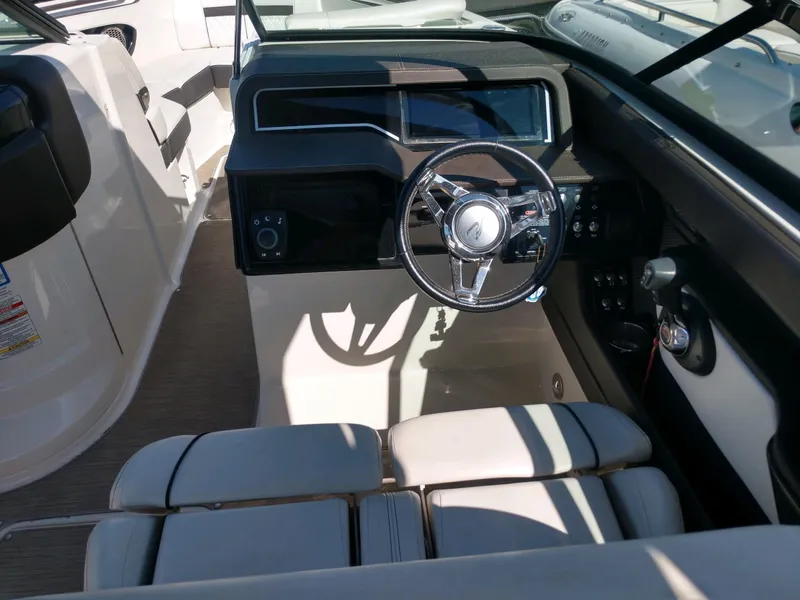 Slide: The Image of 2018 Sea Ray SLX 280 boat cockpit with steering wheel and seating. - 13
