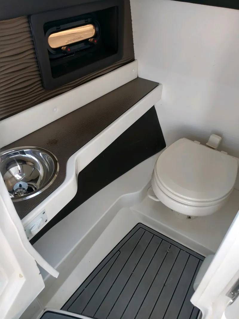 Slide: The Image of 2018 Sea Ray SLX 280 boat interior bathroom with sink and toilet. - 14