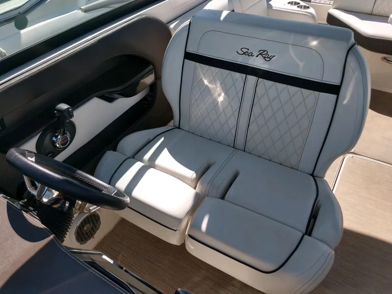 Slide: The Image of 2018 Sea Ray SLX 280 boat interior with luxurious seating and steering wheel. - 16
