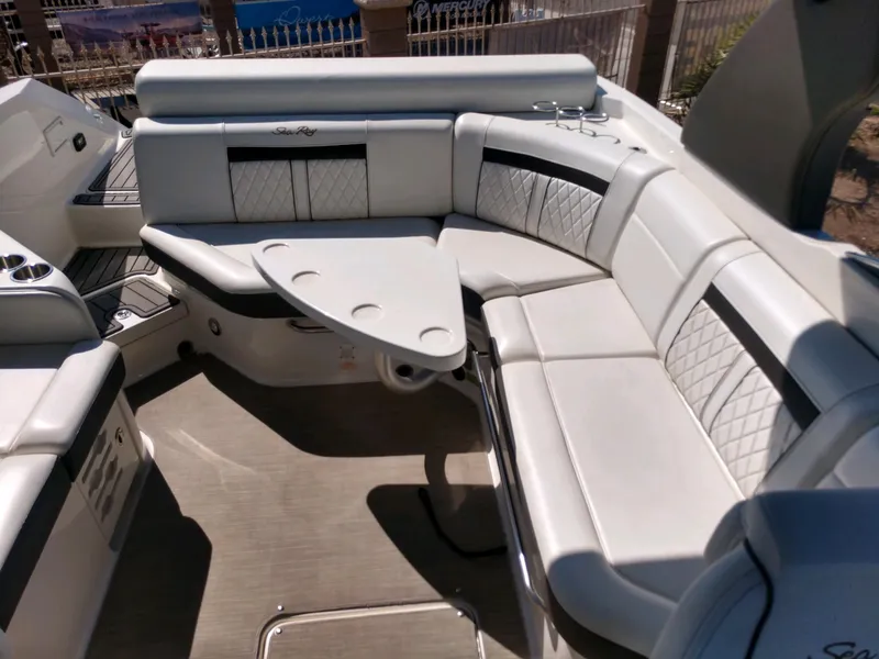 Slide: The Image of 2018 Sea Ray SLX 280 boat interior with white leather seating and table. - 18