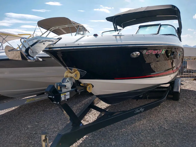 Slide: The Image of 2018 Sea Ray SLX 280 boat on a trailer in a sunny outdoor setting. - 3