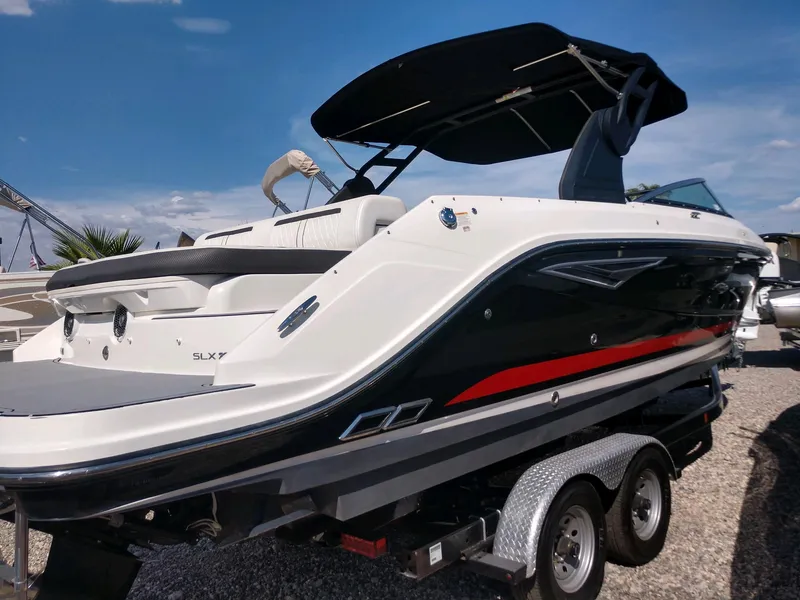 Slide: The Image of 2018 Sea Ray SLX 280 boat on trailer under clear blue sky. - 7