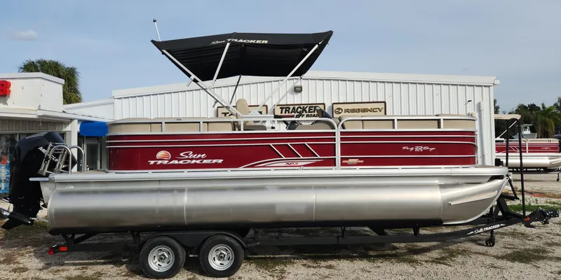 The Image of 2023 Sun Tracker Party Barge 22 XP3 pontoon boat on trailer, side view. - 0