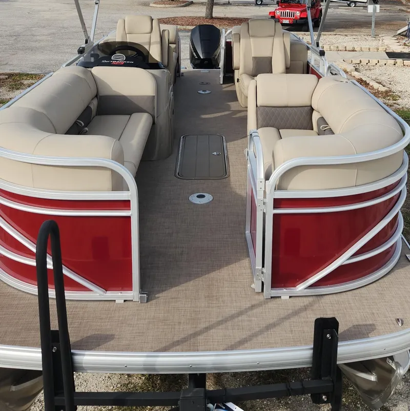 Slide: The Image of 2023 Sun Tracker Party Barge 22 XP3 pontoon boat with beige seating and red exterior. - 3
