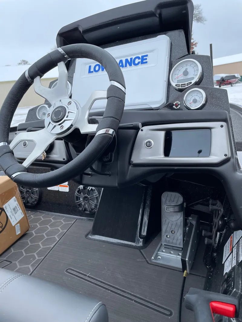 Slide: The Image of 2023 Nitro Z20 boat dashboard with steering wheel and Lowrance electronics. - 4